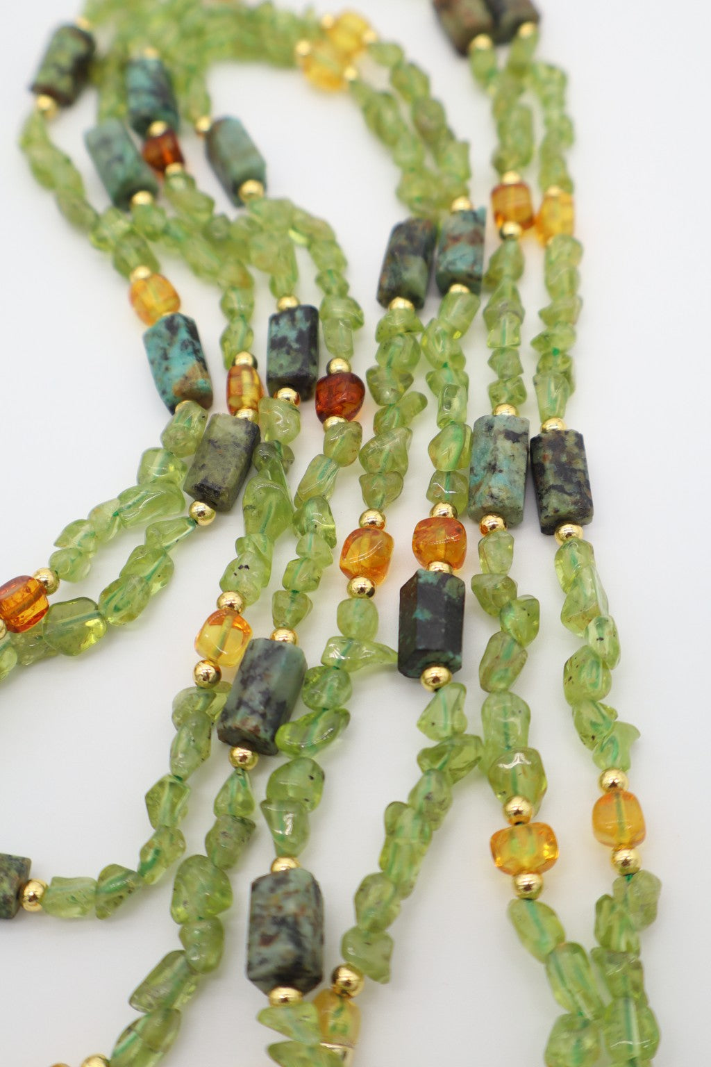 Collana Prestige in pietre naturali autentiche, peridoto, ambra baltica e turchese africano