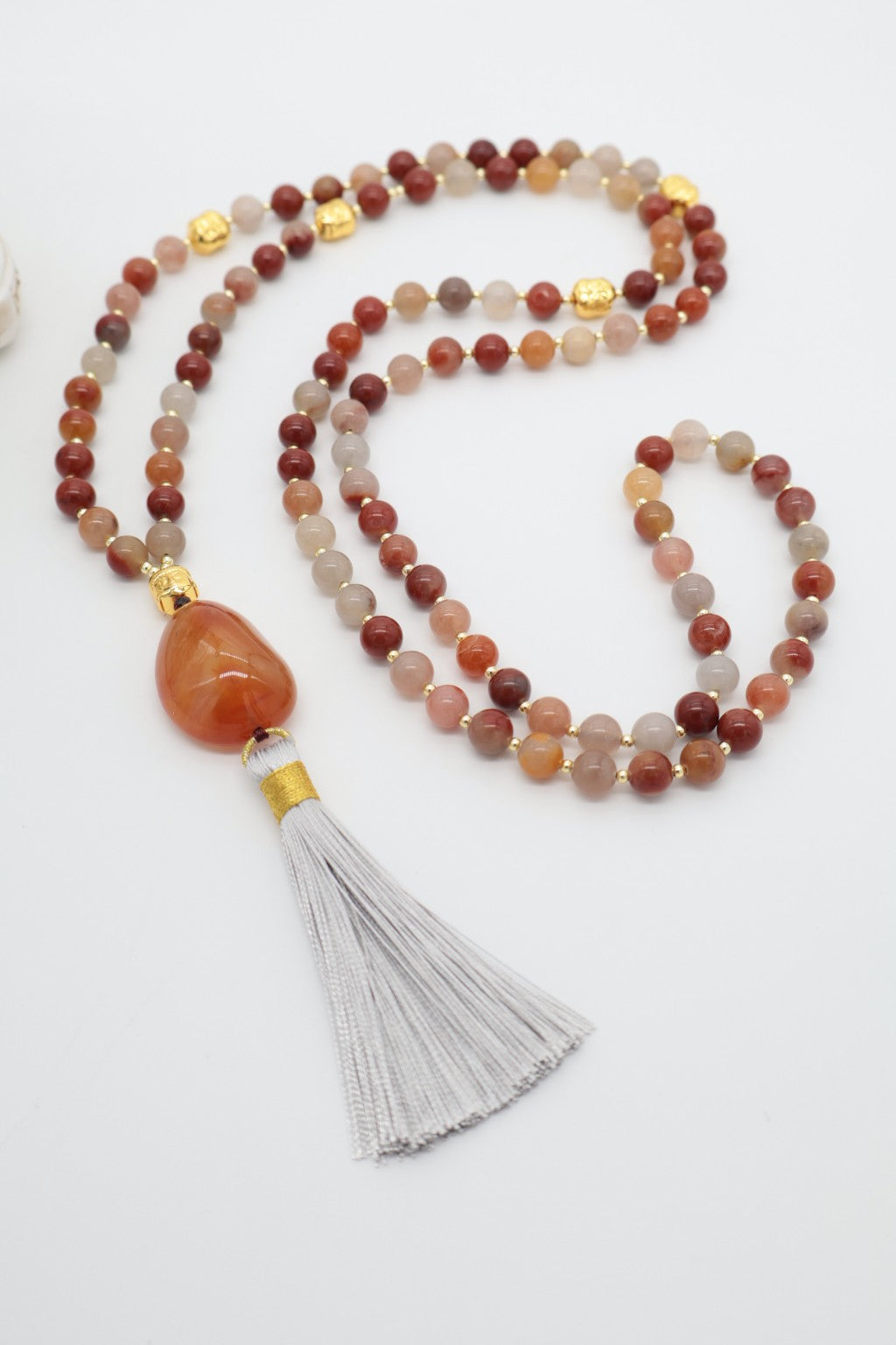 Mala dell’Evoluzione in Diaspro Rosso Multicolor e Corniola con 108 perle, piccoli Buddha dorati e nappina grigia
